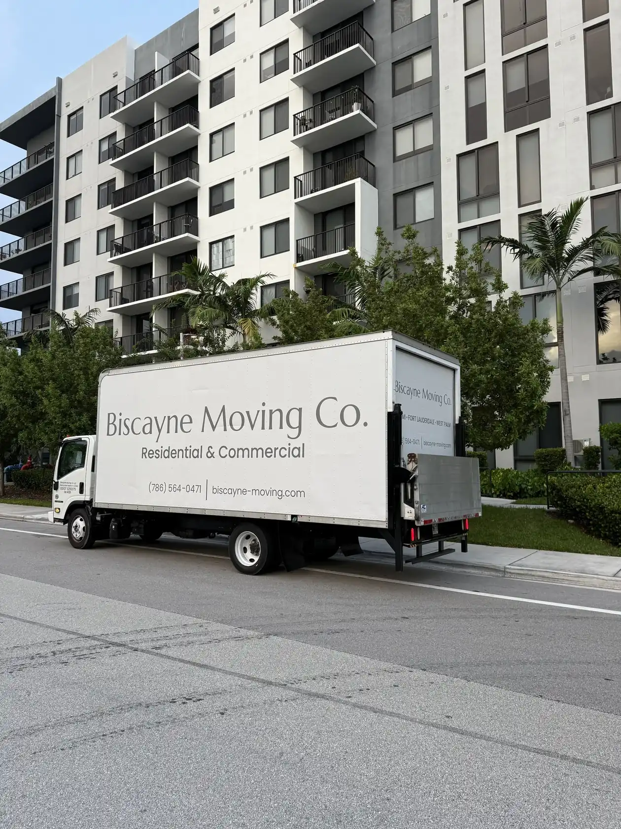 Biscayne Moving Co. truck with lift gate parked outside an apartment building in South Florida