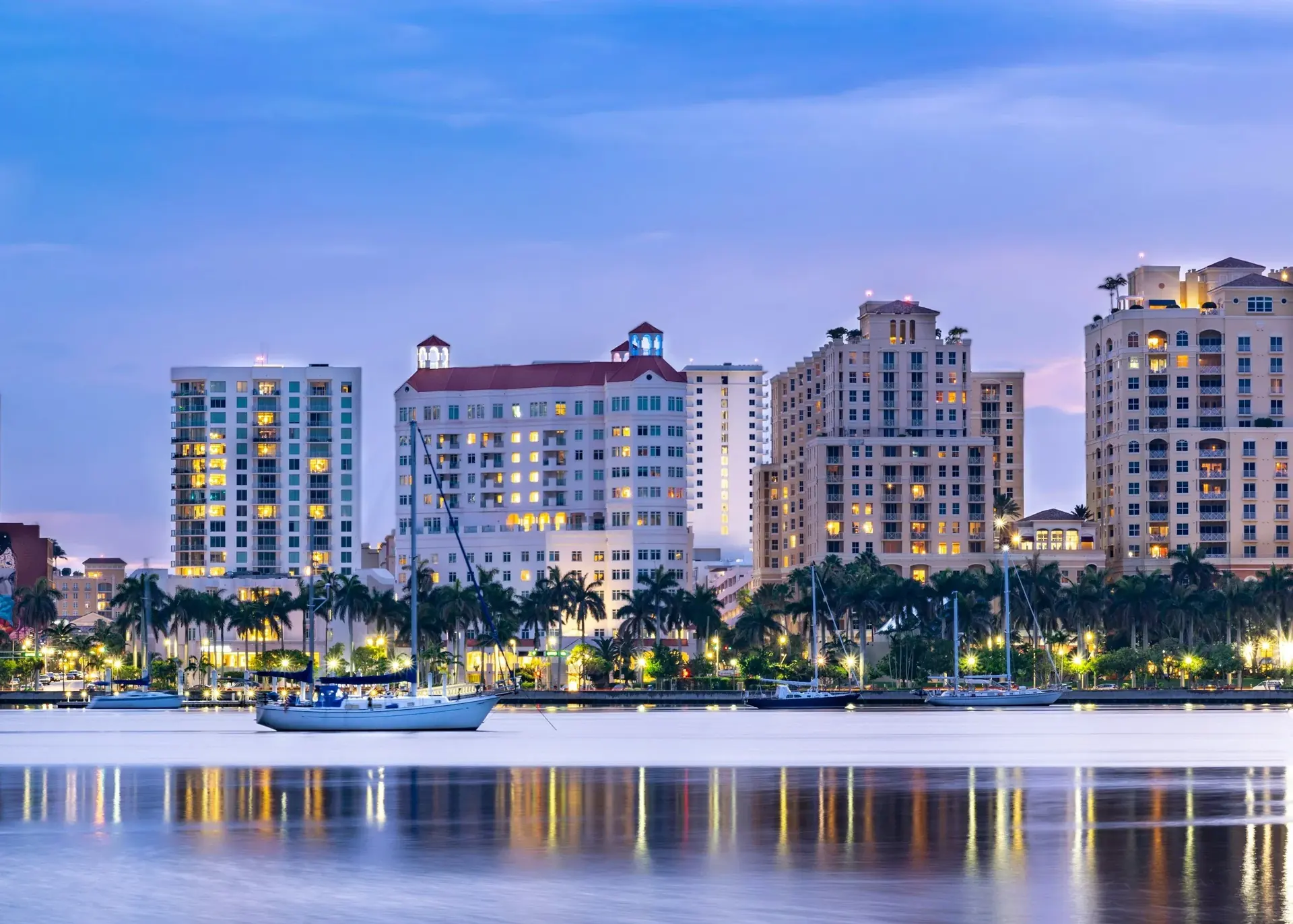 West Palm Beach waterfront buildings reflected in the water at dusk