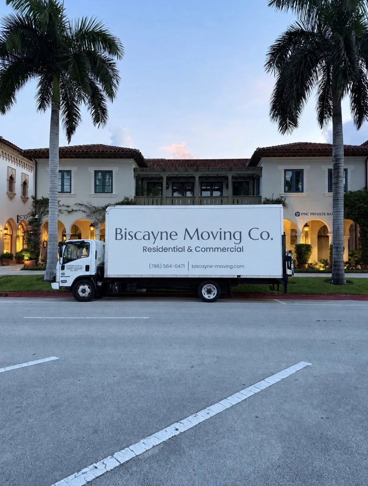 Biscayne Moving Co. truck parked outside a Miami office plaza at dusk