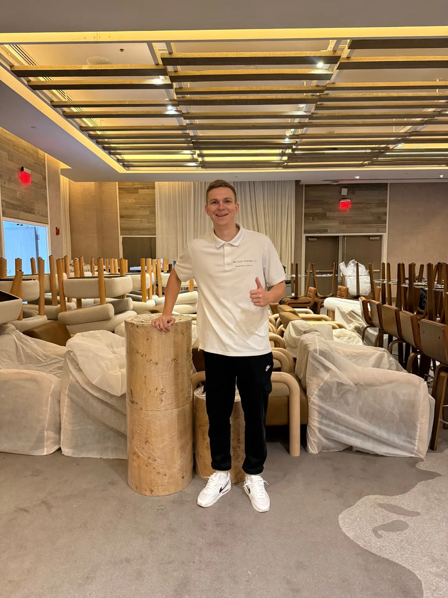 Biscayne Moving Co. crew member with wrapped furniture during an office move in Miami