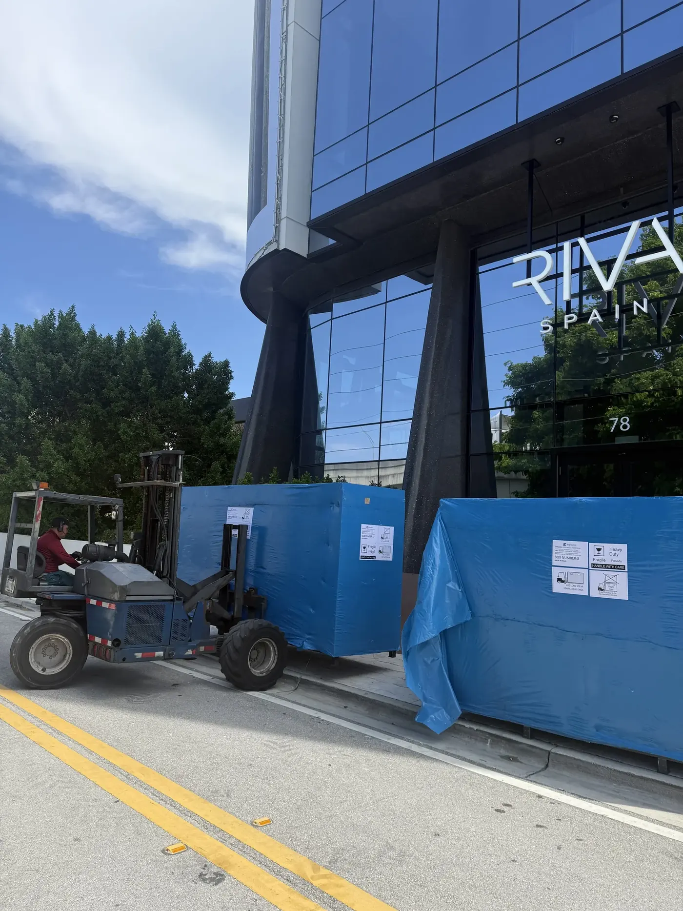 Biscayne Moving Co. truck unloading tile pallets at a Wynwood showroom