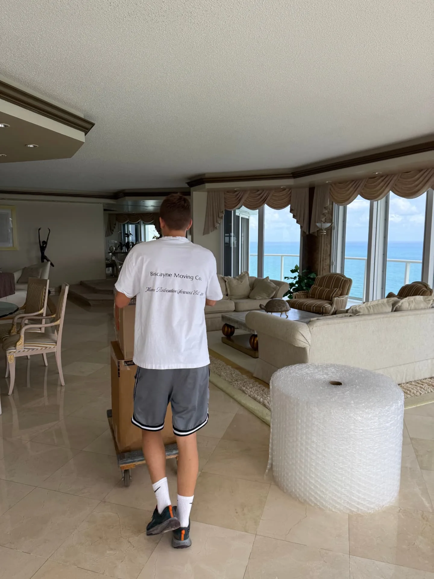 Biscayne Moving Co. mover carrying furniture through a Hollywood condo