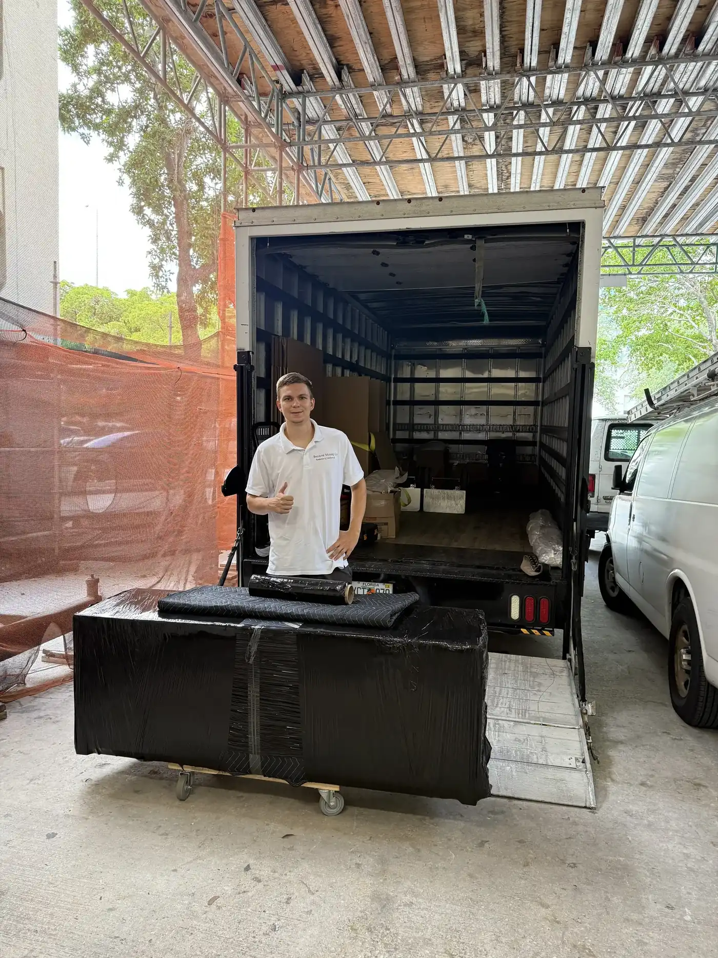 Biscayne Moving Co. truck at the entrance of a Miami condo tower