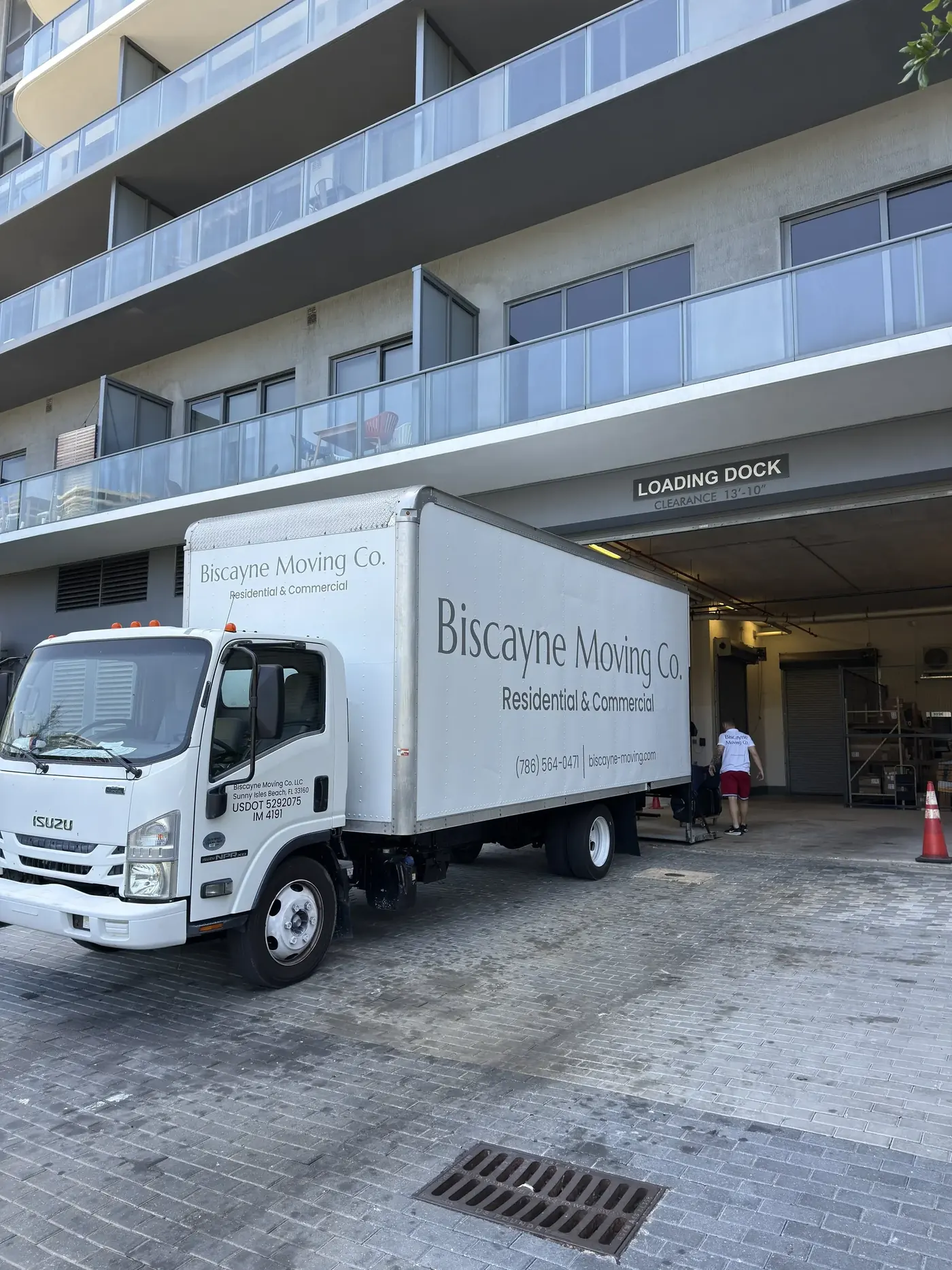 Biscayne Moving Co. truck parked outside a Brickell high-rise