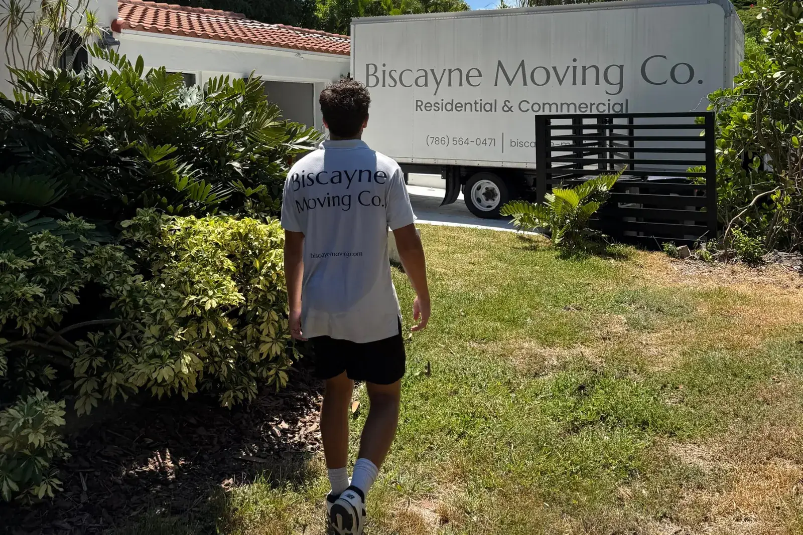 Biscayne Moving Co. crew member walking to the moving truck at a Miami Beach home